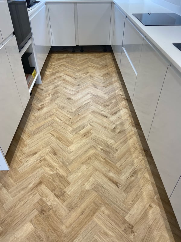Herringbone LVT flooring in a white gloss kitchen